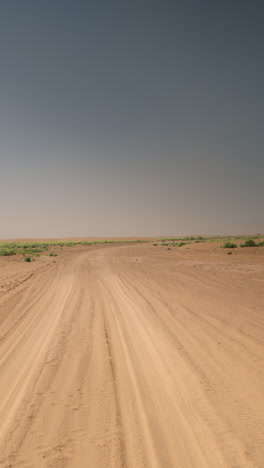 driving-in-sahara-desert,-morocco-in-vertical