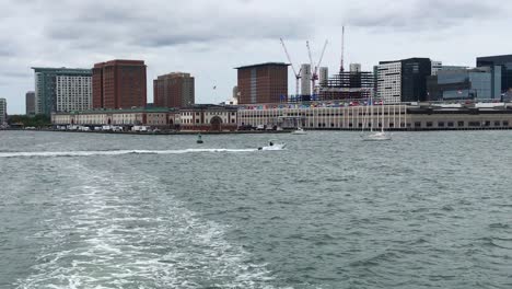 boston harbor, massachusetts.  sailboats, boats, cityscape, pleasant summer day, clouds, view from water