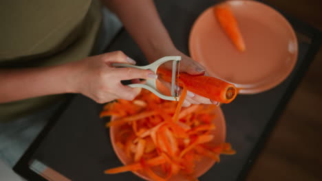 woman peeling carrots