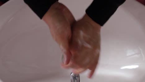 african man drying his hands after washing hands corona virus