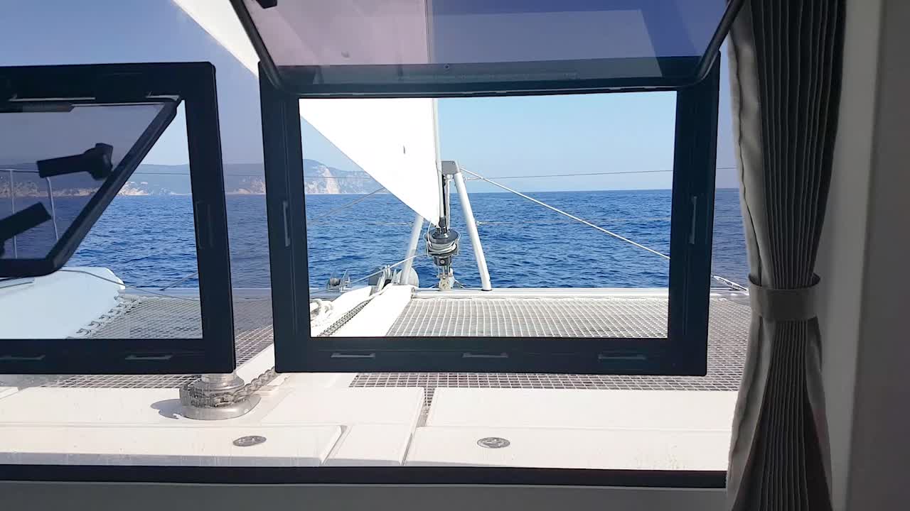 vista frontal del catamarán que se aleja a través de la ventana dentro de la cabina