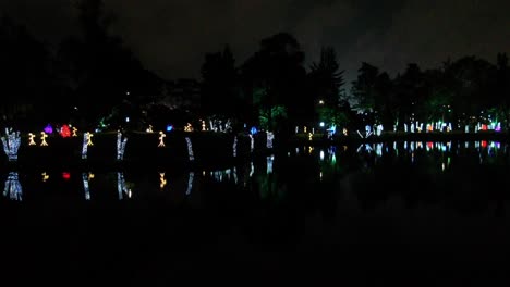 bridge and groom park illuminated by christmas lights during the night in bogotá colombia. drone panning shot