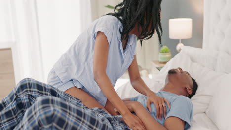 Funny,-playful-and-happy-black-couple-on-bed