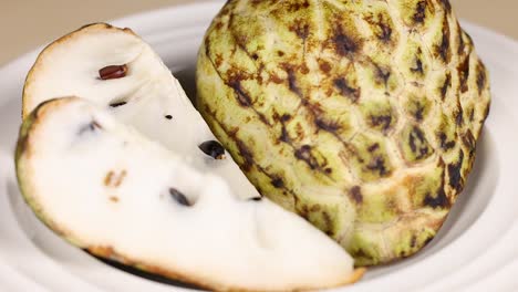 sliced custard apple displayed on a plate