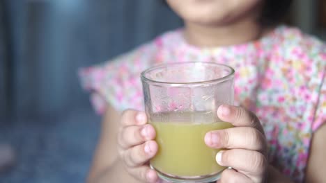 little girl drinking sugarcane juice