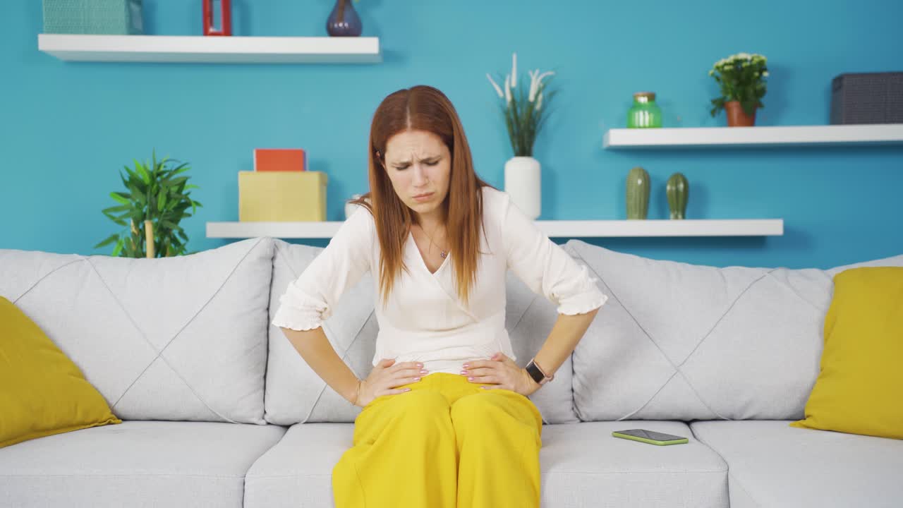 Young woman with stomachache.
