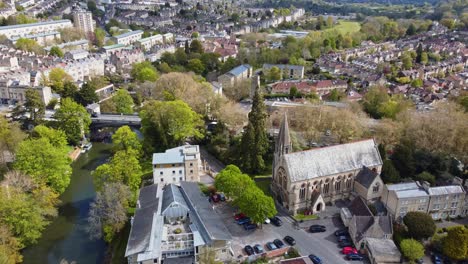 Quaint-southern-UK-suburban-setting,-church,-bridge,-residential-areas-amongst-vast-green-areas