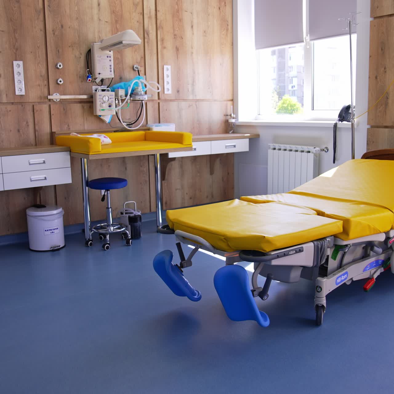 Comfortable equipped folding bed at delivery unit. Clean empty equipped hospital ward for women in labor