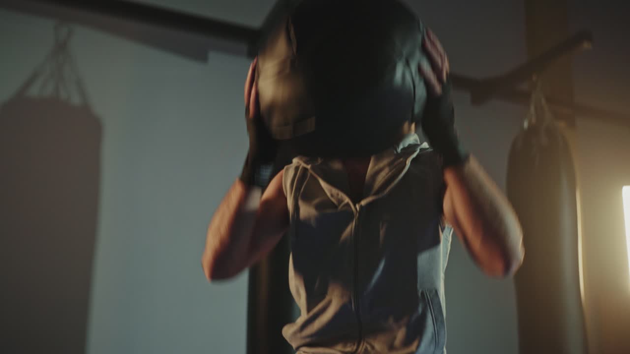 Man Working Out with a Medicine Ball in a Gym