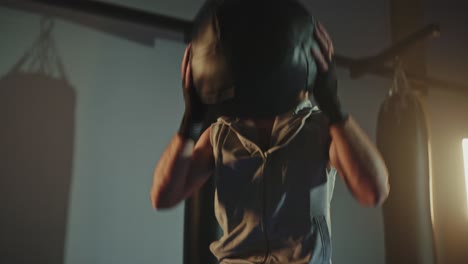 man working out with a medicine ball in a gym