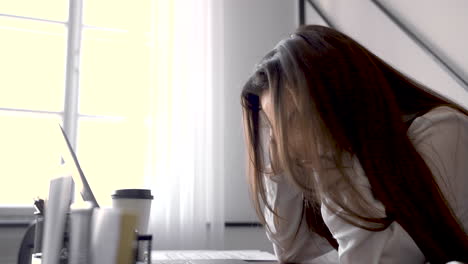 a woman is working with her laptop in an office 1