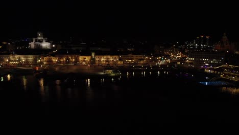 Low-waterfront-aerial:-Helsinki-City-Hall-waterfront-on-black-night