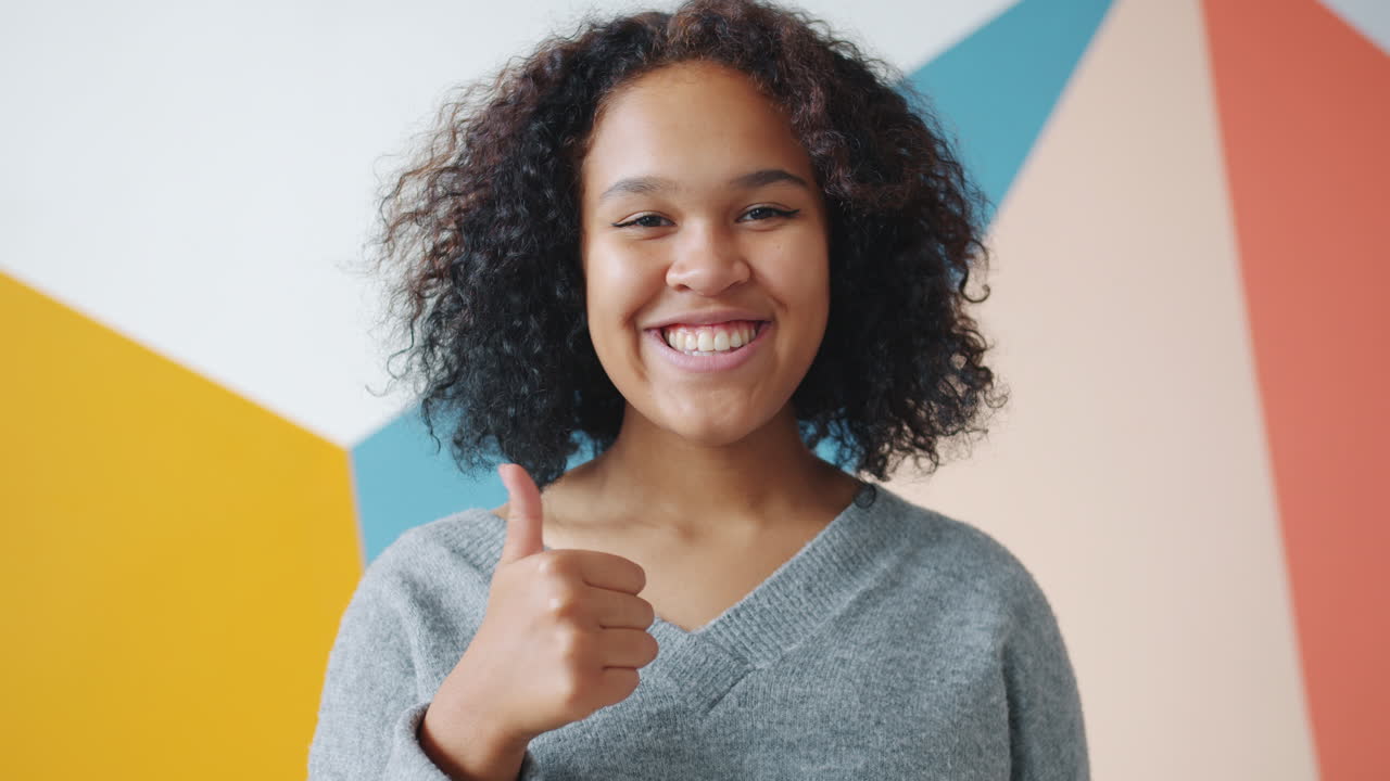 Happy Teen Girl with Thumbs Up