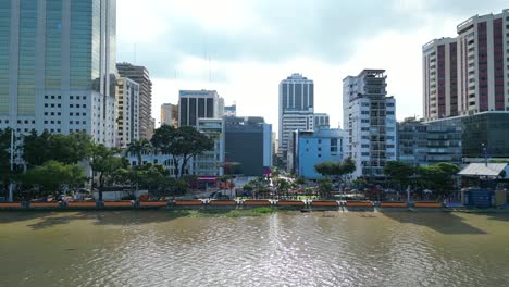 Aerial-fly-by-view-of-Malecon-Simon-Bolivar-river-front-in-Guayaquil,-a-recreational-and-tourist-attraction-place-with-landmarks-and-walking-space-for-local-people-and-tourists