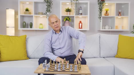 the old man plays chess by himself and is thoughtful.