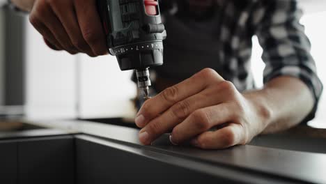 handheld video of carpenter using a cordless drill