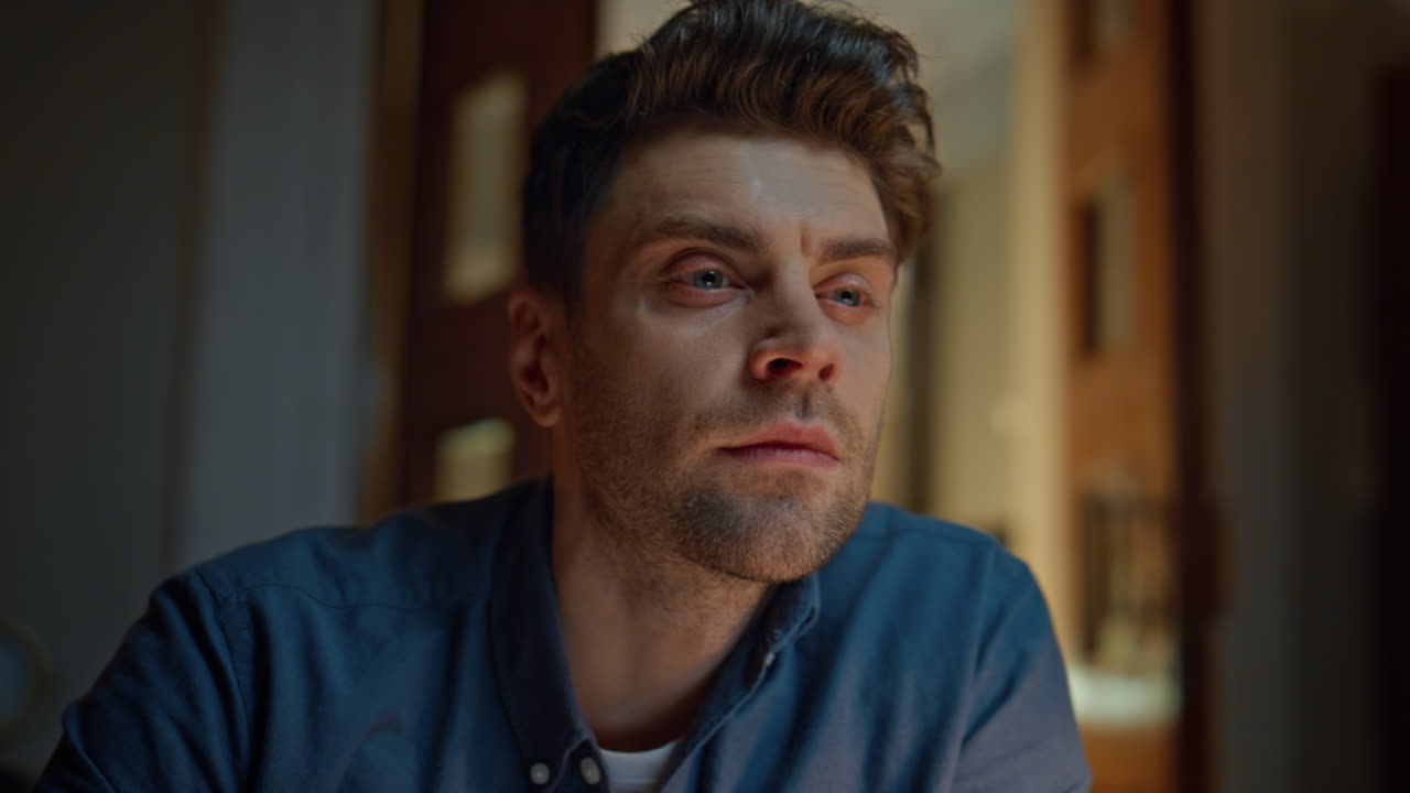 Focused manager staring pc screen at night flat low angle. Closeup frowning guy