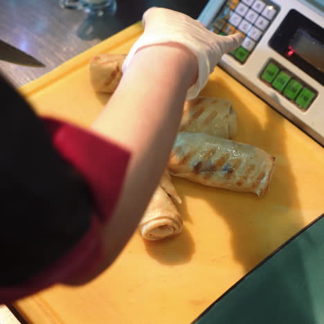 chef cutting pancakes on a board. pancakes filled with meat filling sqare video