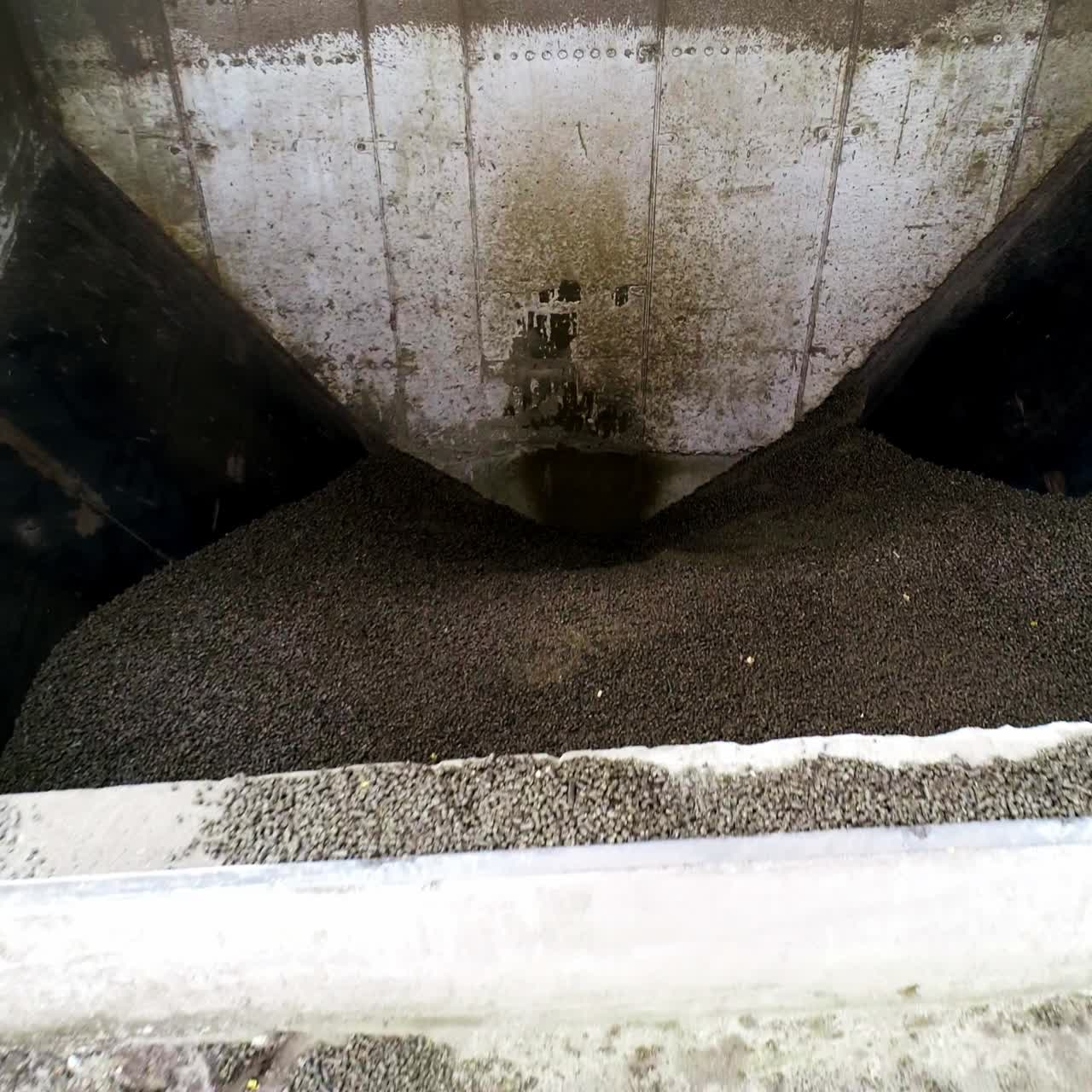 Basement premise for charcoal storage at the up-to-date grain processing plant. Close look at the charcoal with gradual rising over the basement