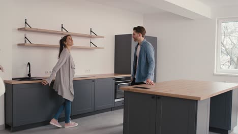 real estate agent showing new house to young caucasian couple