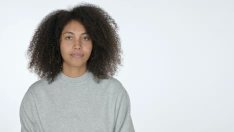 young african woman pointing at product, white background