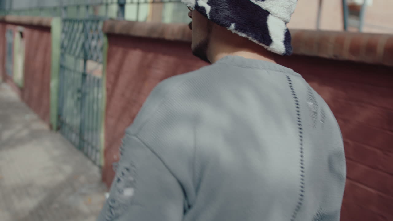 Musician Walking with Guitar and Smoking on the Street