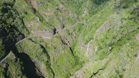 Scenic-mountainous-road-curving-along-dramatic-valley,-Madeira