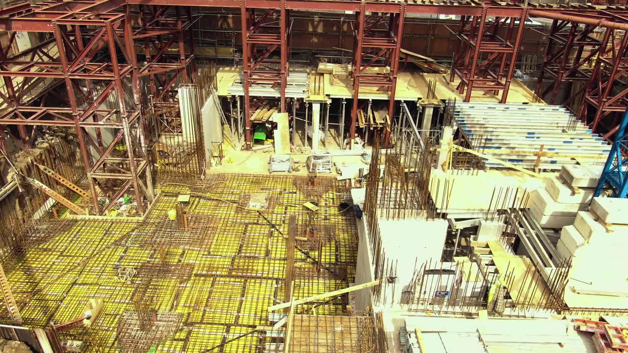 Construction Site Aerial View: Steel Framework and Concrete Foundation