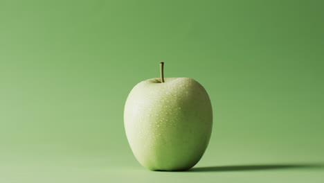 video of green apple with copy space over green background