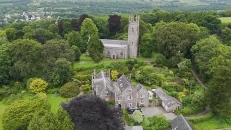 Aerial-view-of-All-Saints-Church-and-its-surroundings-outside-of-Okehampton,-Devon,-UK,-captured-in-July-2024