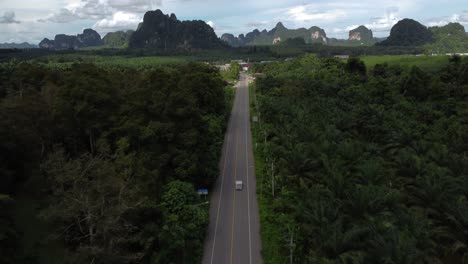 aerial of car road with the sharp rocky mountainous hills of krabi district