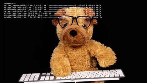 teddy bear with glasses working on a keyboard