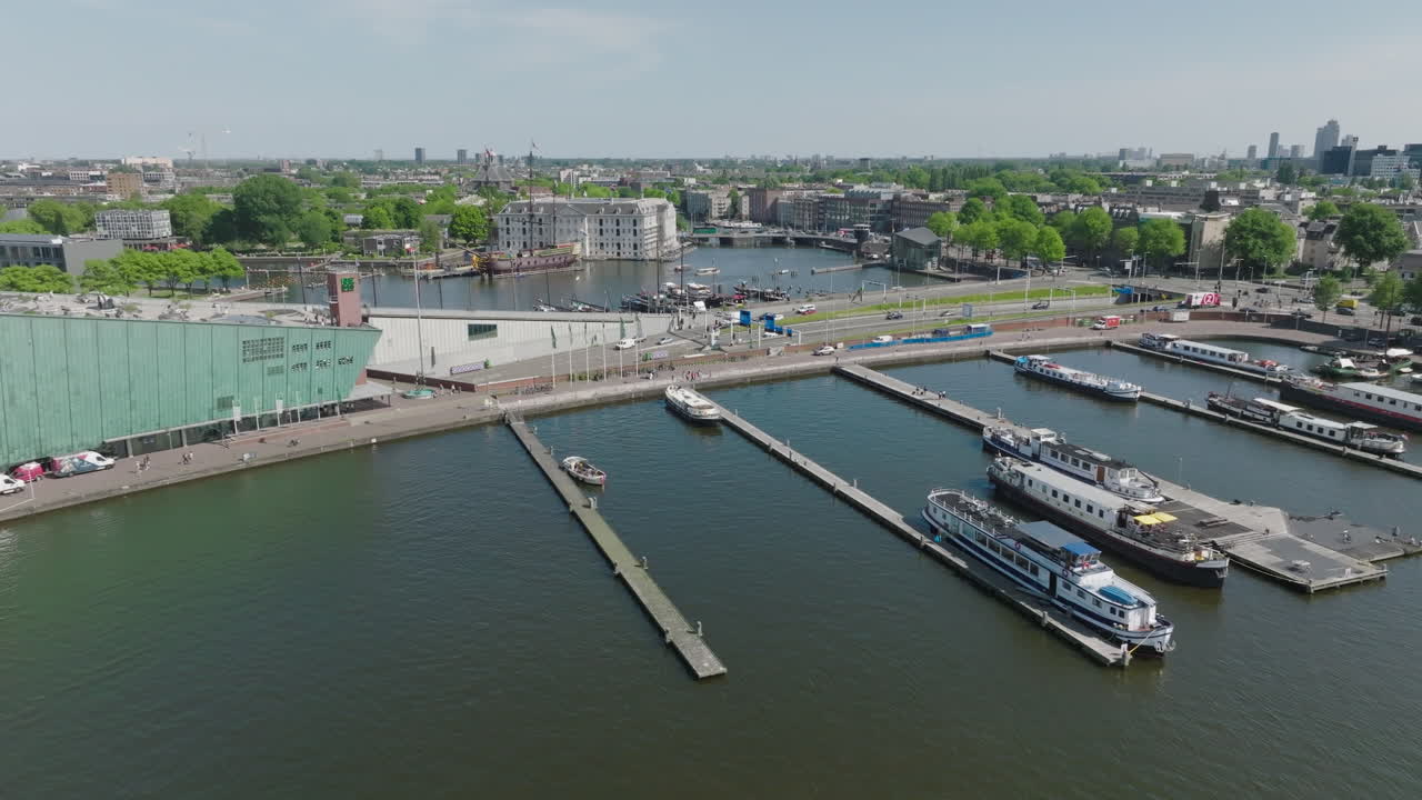 Dutch-type Luxemotor ship with a retracted wheelhouse near of the National Center for Science and Technology Museum NEMO in Amsterdam - Netherlands