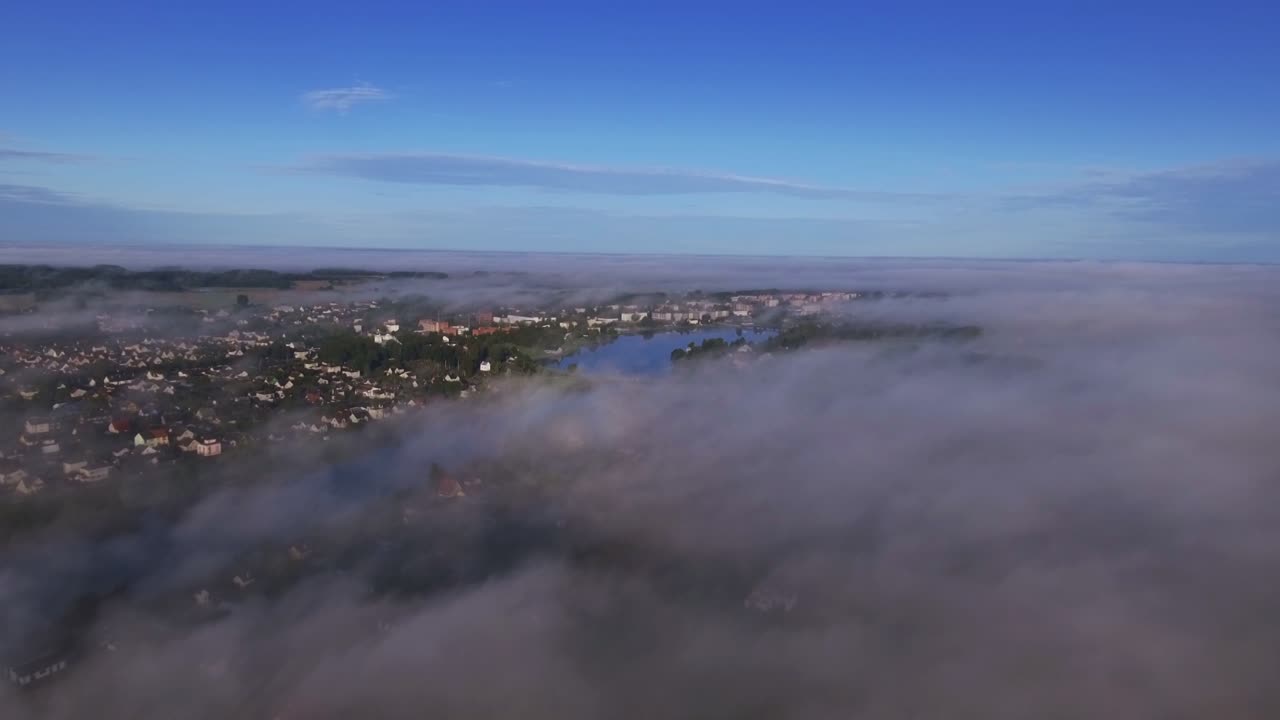 Settlement with a River Surrounded by Thick Morning Mist. Aerial Dolly-In
