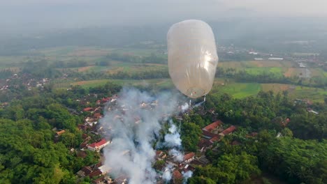 Traditional-hot-air-balloon-with-fire-crackers-on-Idul-Fitri-festival,-Indonesia