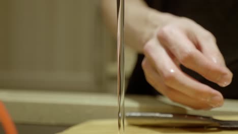 hands washing fresh button mushroom in running water in the kitchen