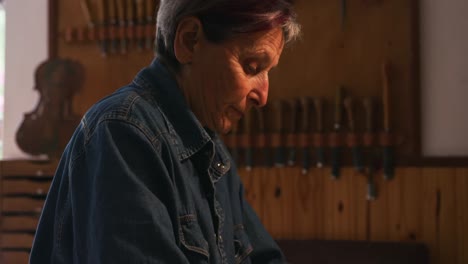 female luthier at work in her workshop