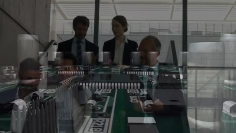 animation of computer circuit board over business people talking in modern office