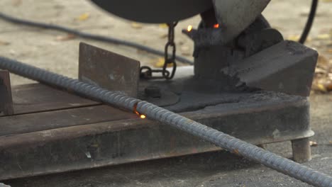 worker sawing cut metal line with a circular saw