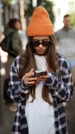 teenager texting on smartphone in city