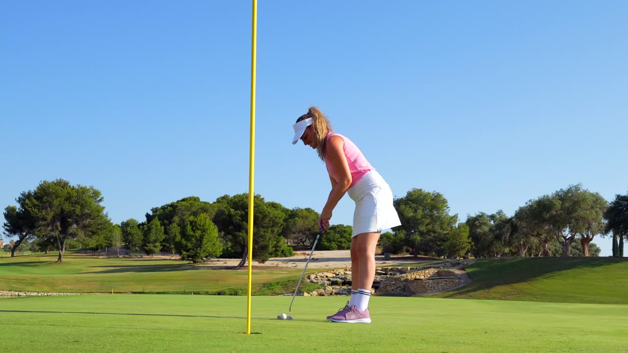 A woman playing golf on a beautiful course