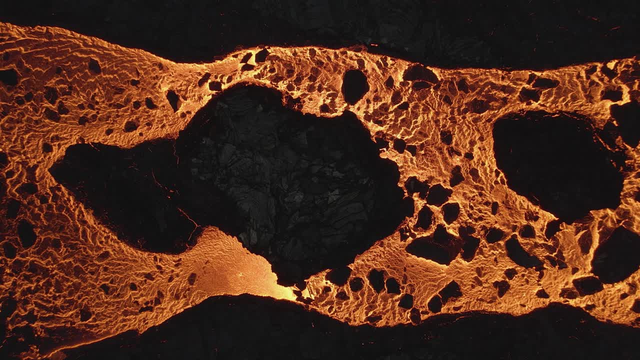 río de lava que fluye lentamente a través de rocas solidificadas negras