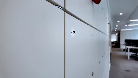 Close-up-shot-of-modern-office-lockers-organized-in-a-row-with-numbered-labels,-providing-efficient-storage-solutions-in-a-work-environment