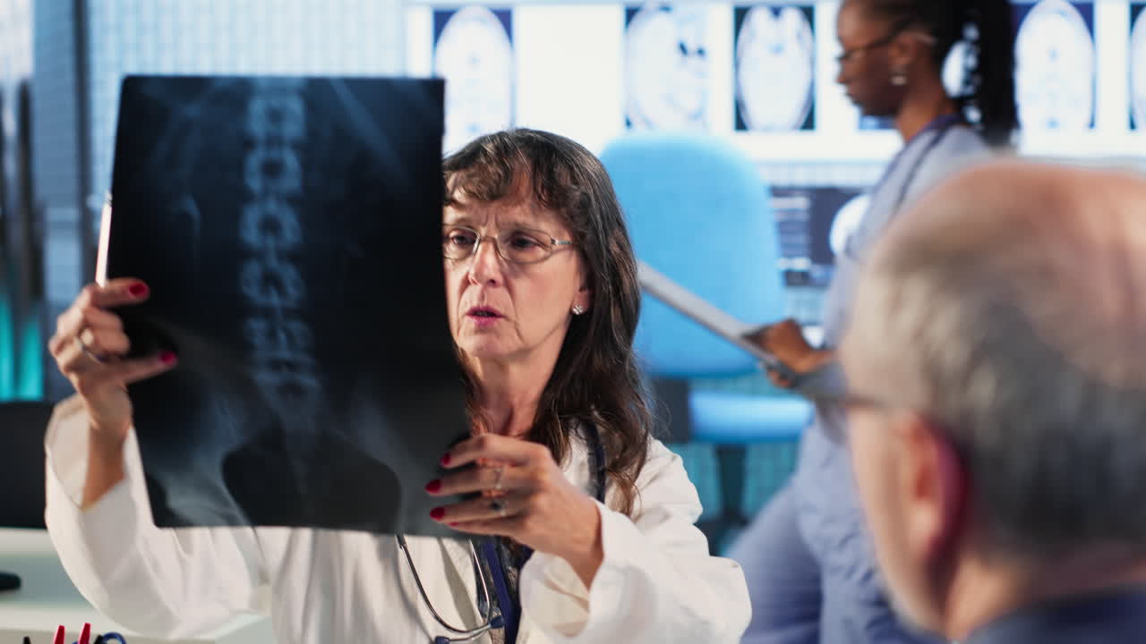 Vertical Video Female general practitioner giving bad worrying news to elderly man