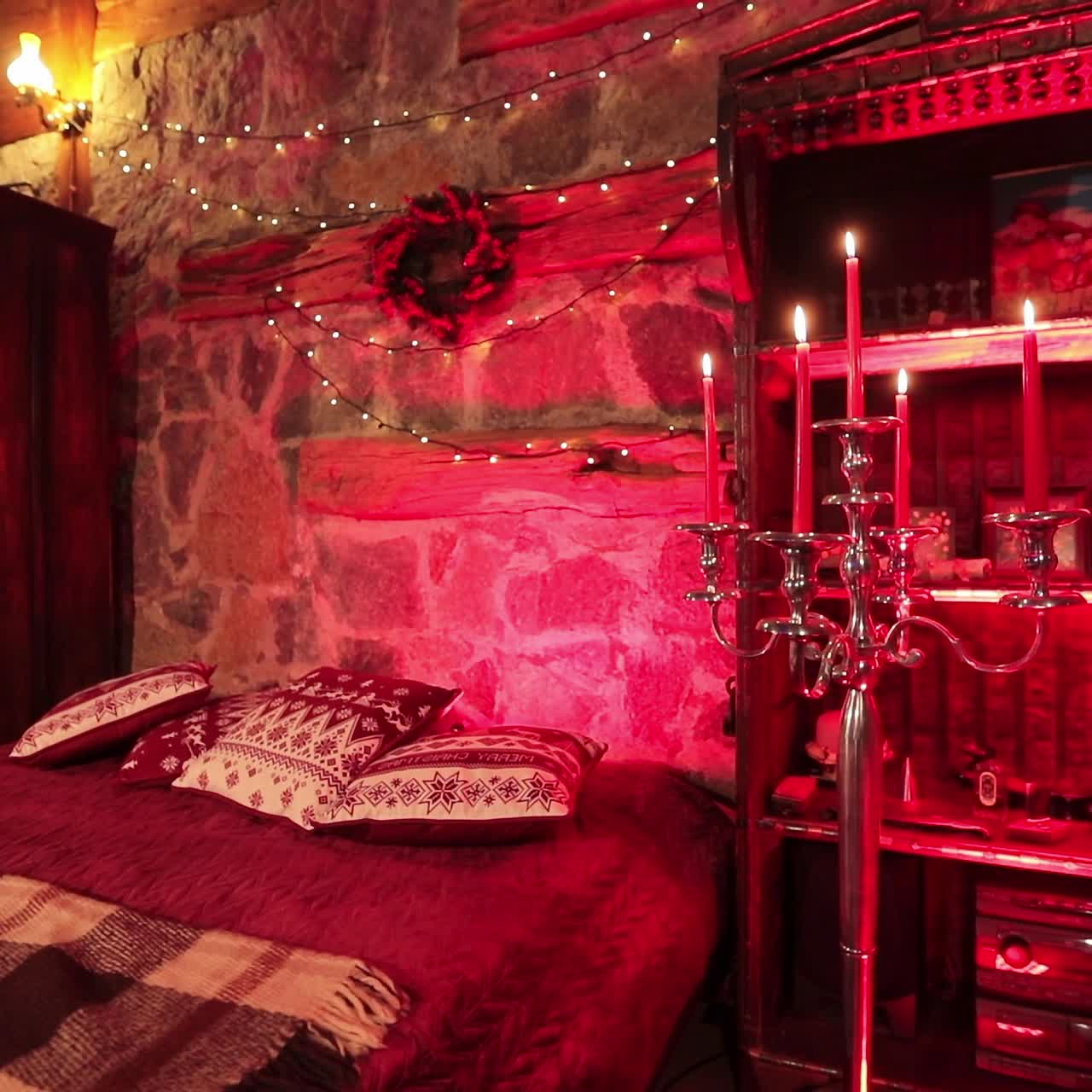 Old-fashioned countryside bedroom in the private manor. Wooden carved furniture, candles and decoration lights in the room for two