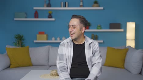 the man promoting is pointing to the side and laughing.