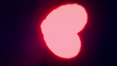red energy heart shapes on a dark background