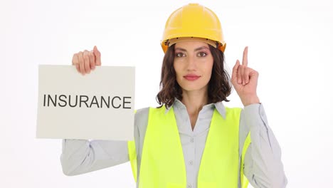 woman in safety gear holding 'insurance' sign and pointing