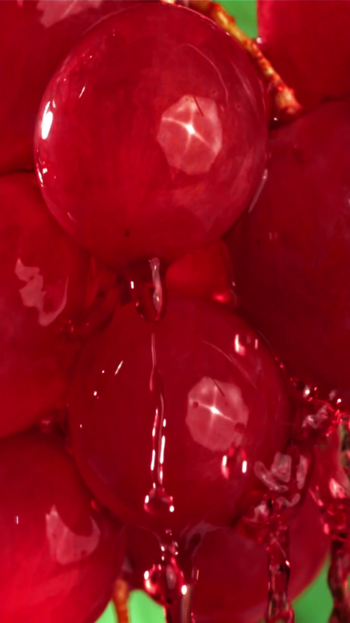 Red Liquid Dripping on Fresh Grapes in Slow Motion