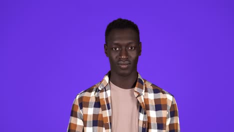 cheerful man in plaid shirt inviting, waving hands, offering to join. young black man gesture over blue background